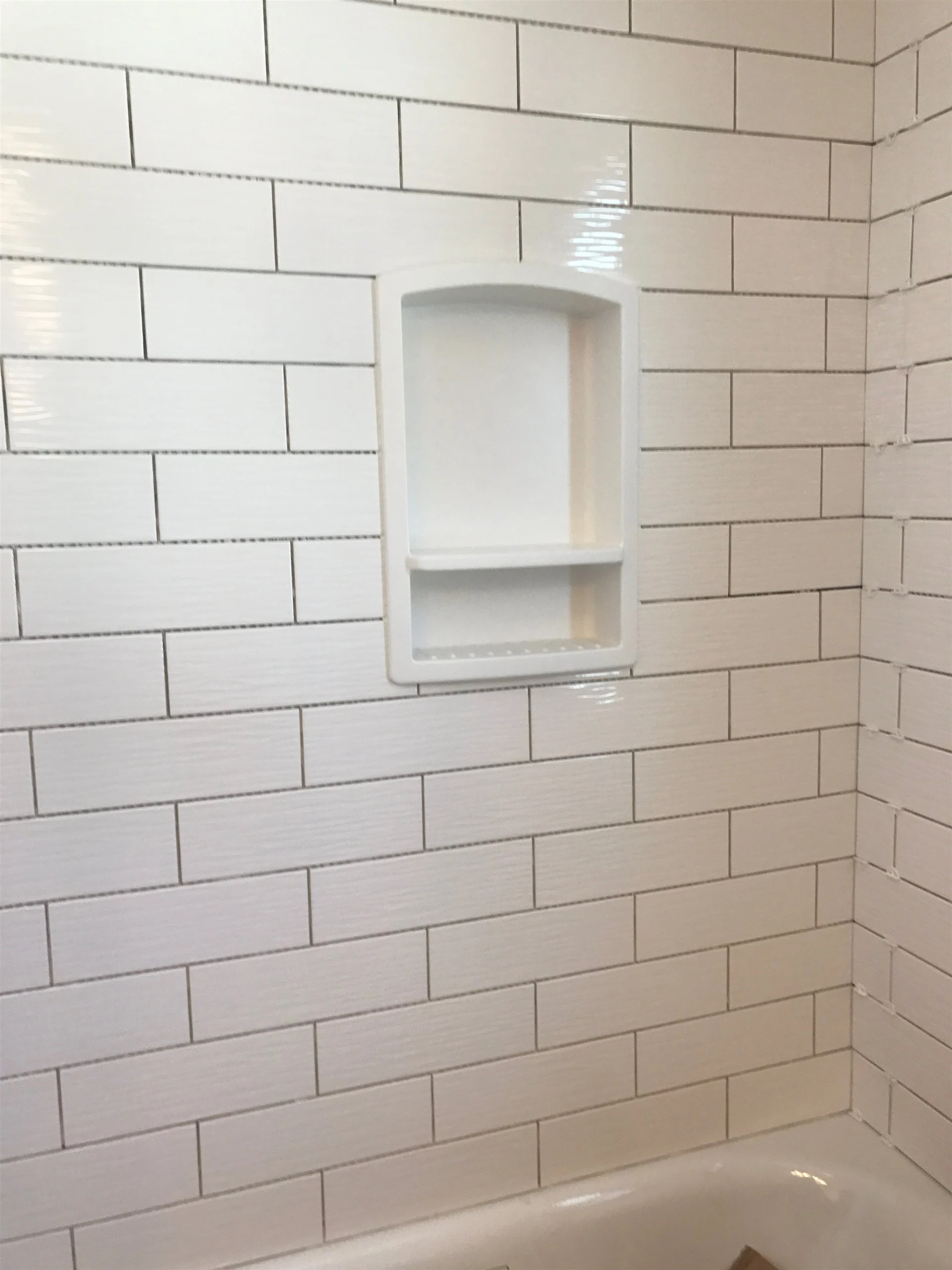 White subway tile shower wall